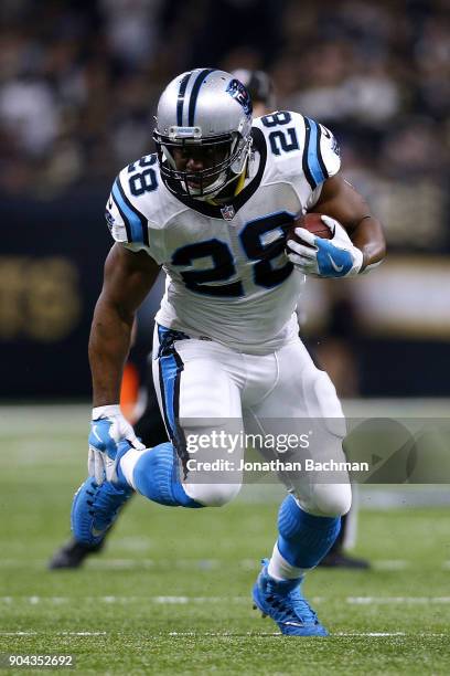 Jonathan Stewart of the Carolina Panthers runs with the ball during the NFC Wild Card playoff game against the New Orleans Saints at the...