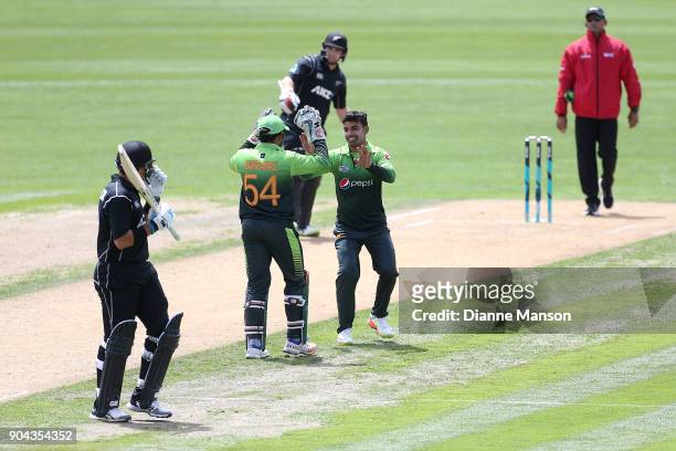 Sarfraz Ahmed and Shadab Khan of Pakistan celebrate the dismissal of Ross Taylor of New Zealand during the third game of the One Day International...