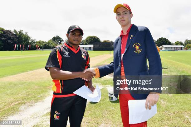 Captains Vagi Karaho of Papua New Guinea and Liam Roche of Zimbabwe shake hands prior to the ICC U19 Cricket World Cup match between Zimbabwe and...