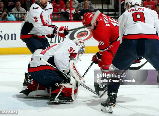 Philipp Grubauer of the Washington Capitals smothers a scoring attempt from Marcus Kruger of the Carolina Hurricanes during an NHL game on January...
