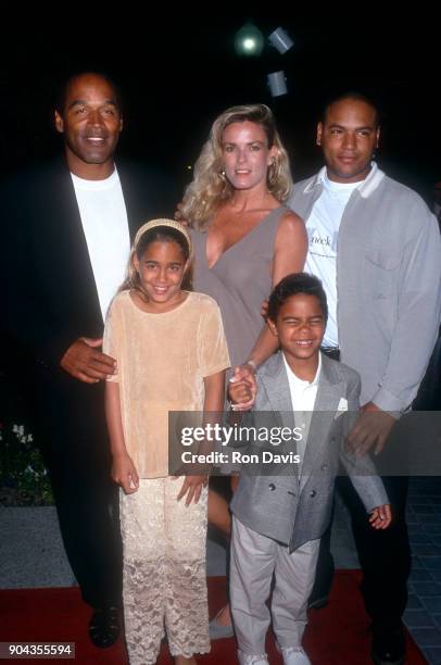 Simpson and Nicole Brown Simpson walk the red carpet with their children Jason Simpson, Sydney and Justin as they attend the 'Naked Gun 33 1/3: The...