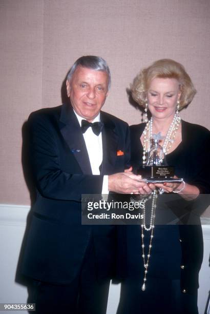 Legendary American singer Frank Sinatra poses with his wife Barbara as they attend the ceremony as Barbara receives the 1993 Women in Show Business...