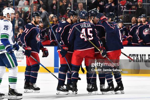 Scott Harrington of the Columbus Blue Jackets celebrates his third period goal with teammates Jack Johnson, Lukas Sedlak and Matt Calvert of the...