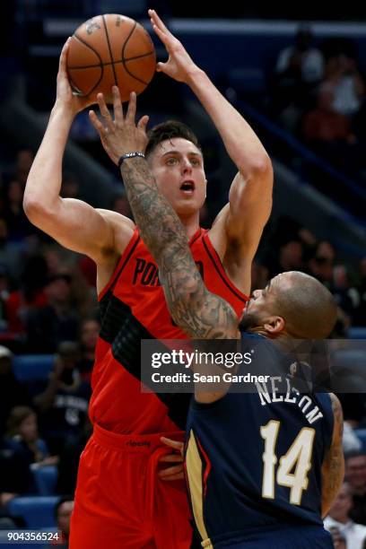 Zach Collins of the Portland Trail Blazers shoots over Jameer Nelson of the New Orleans Pelicans during the first half at the Smoothie King Center on...