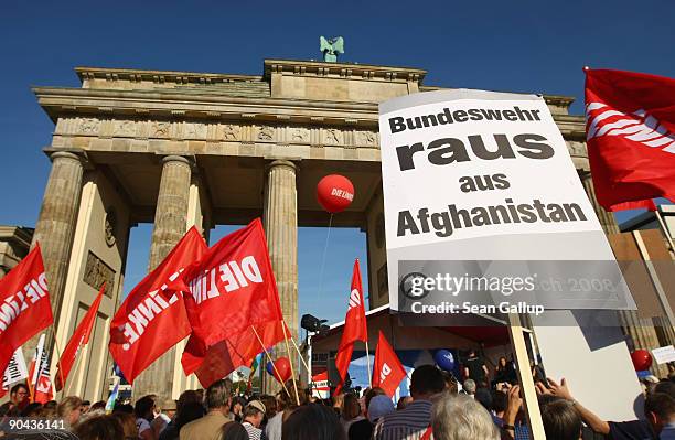 Supporters of the Die Linke left-wing political party carrying signs that read: "Bundeswehr Out Of Afghanistan!" at a demonstration against Germany's...