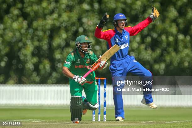 Pinak Ghosh of Bangladesh bats as wicketkeeper Lohan Louwrens of Namibia looks on during the ICC U19 Cricket World Cup match between Bangladesh and...