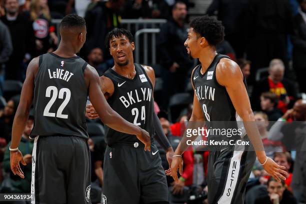 Spencer Dinwiddie, Rondae Hollis-Jefferson and Caris LeVert of the Brooklyn Nets react after their 110-105 win over the Atlanta Hawks at Philips...