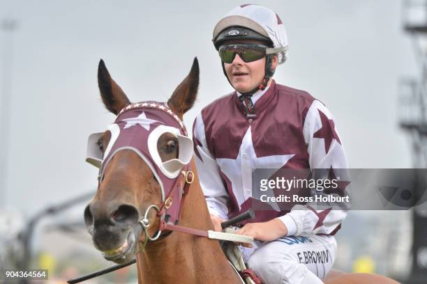 Ethan Brown returns to the mounting yard on Twitchy Frank after winning the Craftsman Handicap at Flemington Racecourse on January 13, 2018 in...