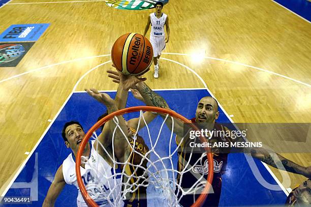 Of Macedonia's Pero Antic jumps to score as Israel's Yaniv Green tries to stop him during their 2009 European championship preliminary round, group...