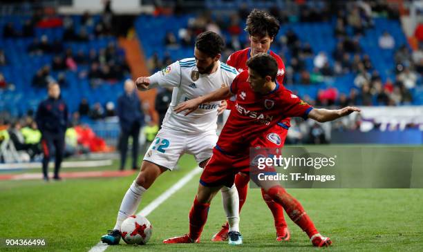 Isco Alarcon of Real Madrid and a player of Numancia battle for the ball during the Spanish Copa del Rey match between Real Madrid and Numancia at...