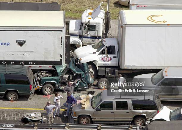 Sports utility vehicle is wedged between two trucks in a multiple car pile up along a foggy stretch of Interstate 75 March 14, 2002 in Ringold, in...