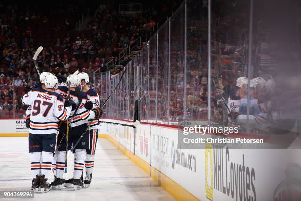 Connor McDavid, Leon Draisaitl, Darnell Nurse and Patrick Maroon of the Edmonton Oilers celebrate after Nurse scored a goal against the Arizona...