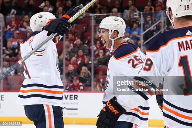 Darnell Nurse of the Edmonton Oilers celebrates with Leon Draisaitl and Patrick Maroon after scoring a goal against the Arizona Coyotes during the...