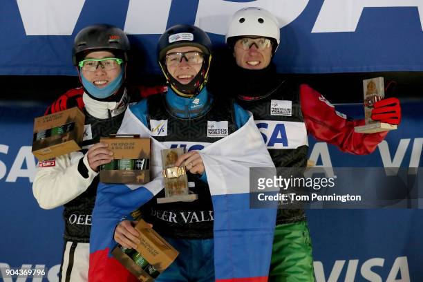 Guangpu Qi of China in second place, Maxim Burov of Russia in first place and Anton Kushnir of Belarus in third place celebrate on the podium in the...