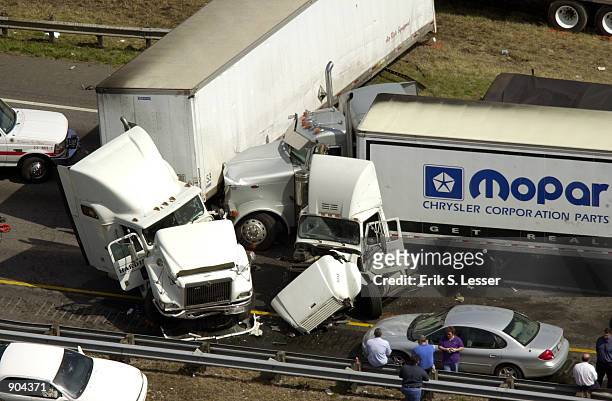 Several tractor trailers are smashed together after a multiple-vehicle pile up along a foggy stretch of Interstate 75 March 14, 2002 in Ringold,...