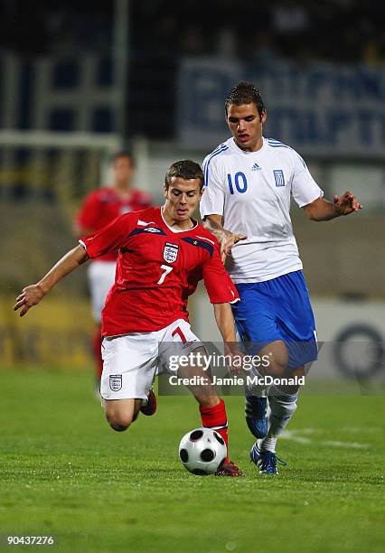 Jack Wilshere of England battles with Panagiotis Tachtsidis of Greece during the UEFA U21 Championship match between Greece and England at the...