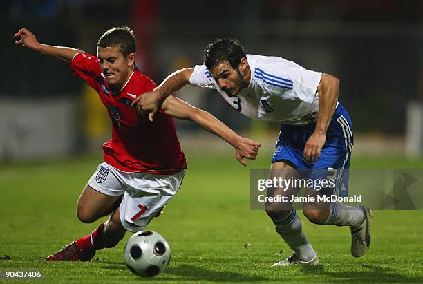 Jack Wilshere of England battles with Michail Boukouvalas of Greece during the UEFA U21 Championship match between Greece and England at the Asteras...