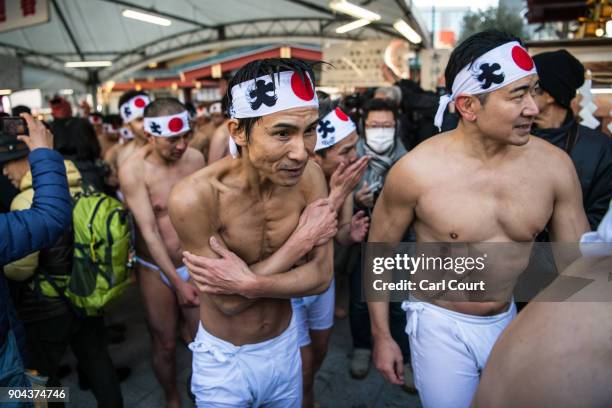 Men leave after taking part in a purification ritual that involved pouring ice-cold water over themselves at Kanda Myojin shrine on January 13, 2018...