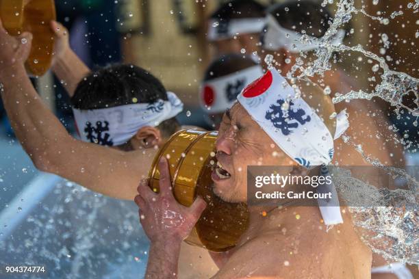 Man pours ice-cold water over himself during a purification ritual at Kanda Myojin shrine on January 13, 2018 in Tokyo, Japan. The coming of age...