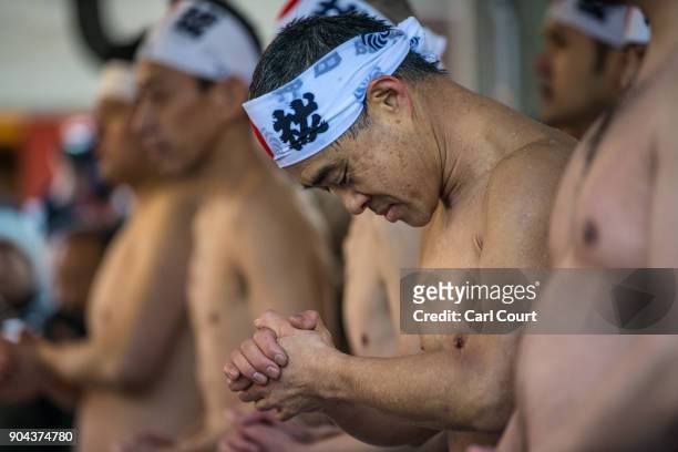 Men queue to reenter a pool as they take part in a purification ritual that involves pouring ice-cold water over themselves at Kanda Myojin shrine on...