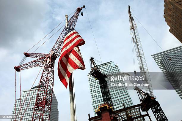 An American Flag flies in front of the construction site of One World Trade Center, known to many as the Freedom Tower, at the former World Trade...