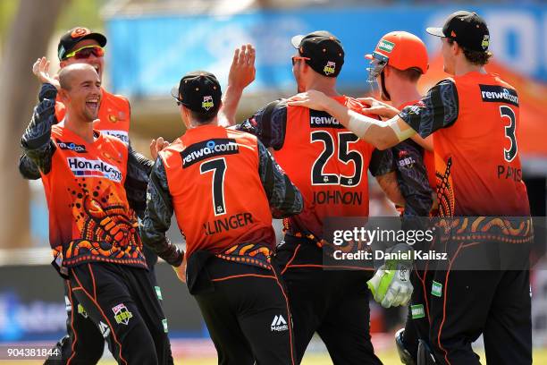 Ashton Agar of the Perth Scorchers celebrates with Mitchell Johnson of the Perth Scorchers during the Big Bash League match between the Adelaide...