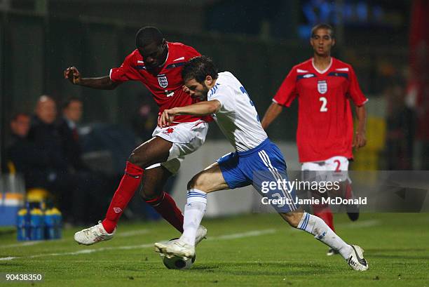 Fabrice Muamba of England and Michail Boukouvalas of Greece compete for the ball during the UEFA U21 Championship match between Greece and England at...