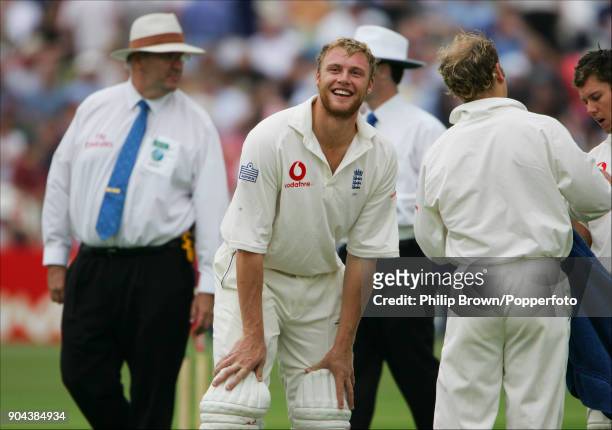 England batsman Andrew Flintoff laughs after his father Colin had failed to catch a six that Flintoff had hit into the stand during his innings of...