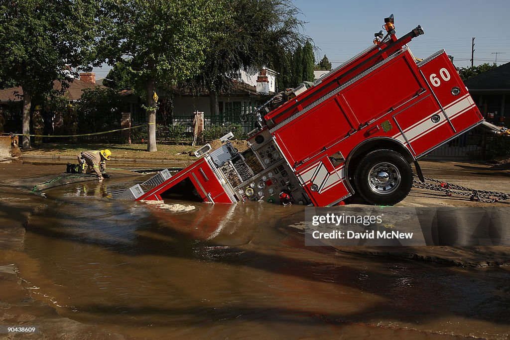 Fire Truck Trapped In Giant Sinkhole