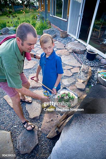 father with son, outdoor pizza oven - pizzaugn bildbanksfoton och bilder