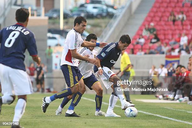 Marcelo Saragosa of Chivas USA kicks the ball against Pablo Campos of Real Salt Lake at Rio Tinto Stadium on August 26, 2009 in Sandy, Utah.