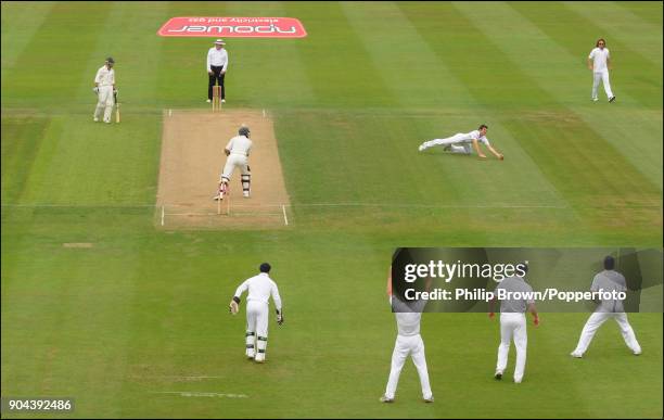 England bowler James Anderson dives to take the catch to dismiss South African batsman Hashim Amla off his own bowling during the 3rd Test match...