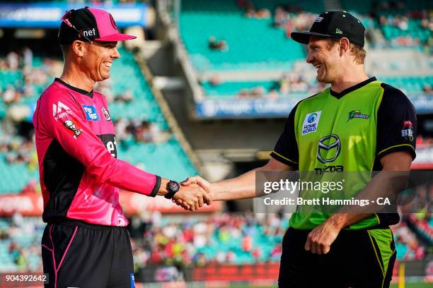 Shane Watson of the Thunder and Johan Botha of the Sixers shake hands after the coing toss during the Big Bash League match between the Sydney Sixers...