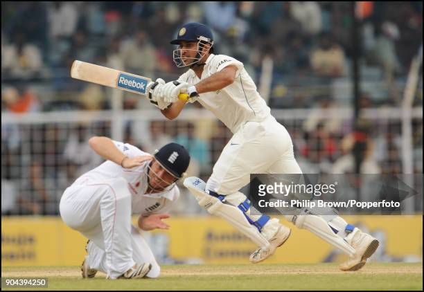 Mahendra Singh Dhoni of India plays a shot past England fielder Ian Bell during the 1st Test match between India and England at MA Chidambaram...