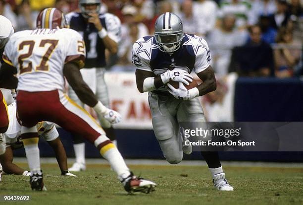 Emmitt Smith of the Dallas Cowboys carries the ball against the Washington Redskins October 1, 1995 during an NFL football game at RFK Stadium in...