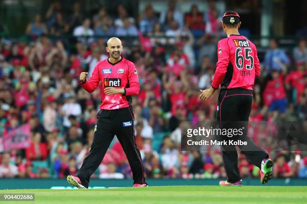 Nathan Lyon of the Sixers celebrates with his team mate Johan Botha of the Sixers after taking the wicket of James Vince of the Thunder during the...