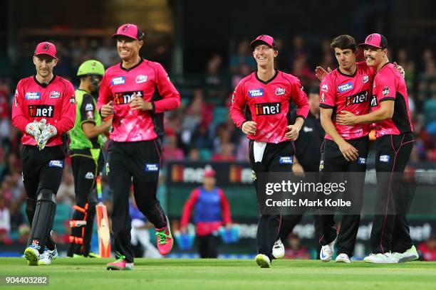 Moises Henriques of the Sixers celebrates with his team after taking the wicket of Callum Ferguson of the Thunder during the Big Bash League match...