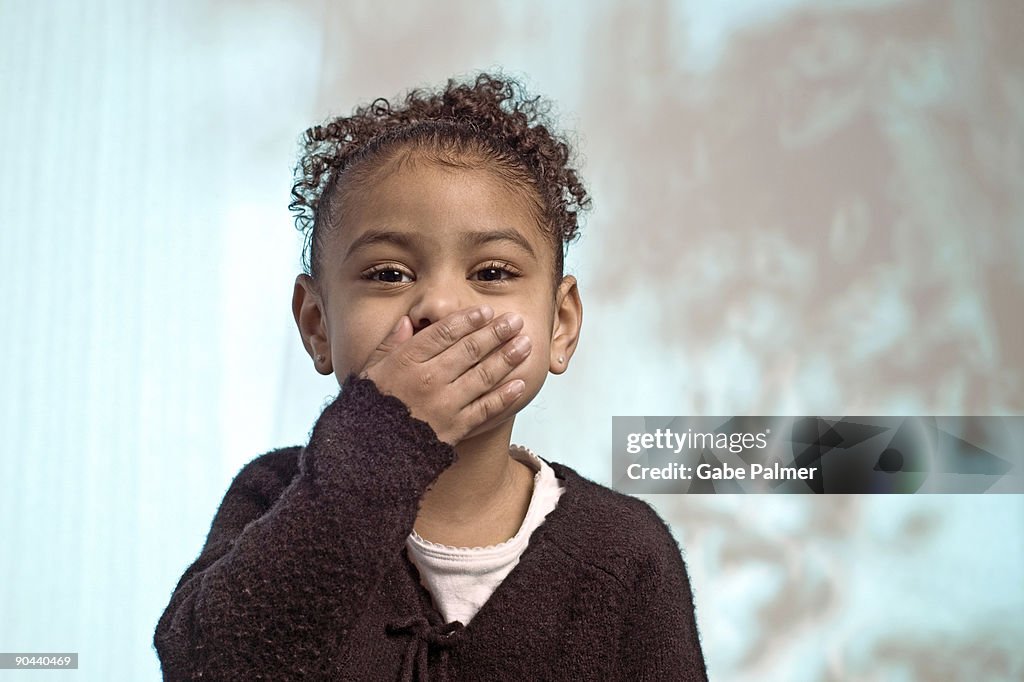 Girl covering mouth