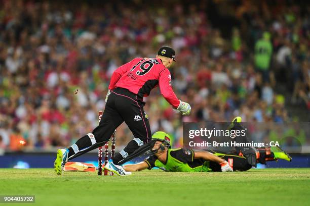 Peter Nevill of the Sixers runs out Chris Green of the Thunder during the Big Bash League match between the Sydney Sixers and the Sydney Thunder at...