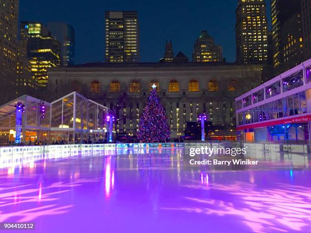 purple glow on ice rink at christmas in bryant park, new york - ice rink no people stock pictures, royalty-free photos & images