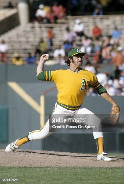 Pitcher Jim Catfish Hunter of the Oakland Athletics pitches during a circa early 1970's Major League baseball game. Hunter played for the Athletics...