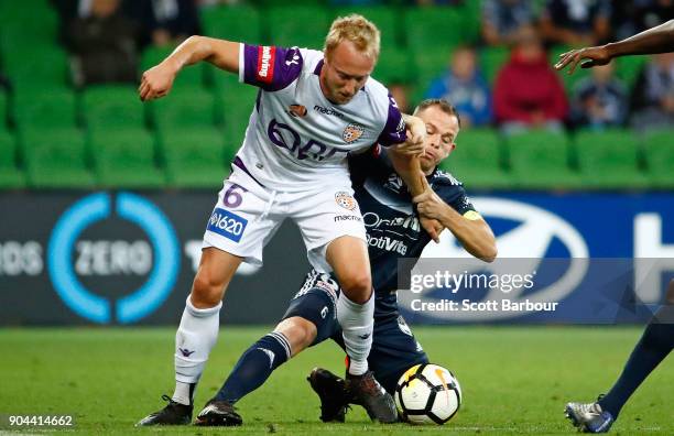 Mitch Nichols of the Glory and Leigh Broxham of the Victory compete for the ball during the round 16 A-League match between the Melbourne Victory and...