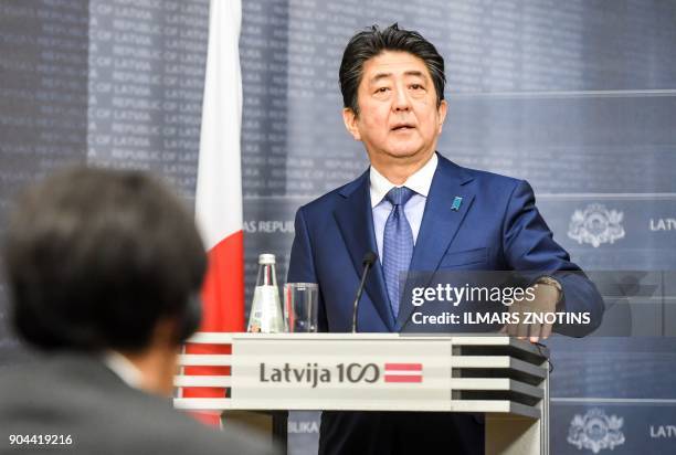 Japan's Prime Minister Shinzo Abe attends a press conference with his Latvian counterpart after their meeting in Riga, Latvia on January 13, 2018. -...