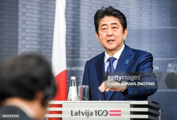 Japan's Prime Minister Shinzo Abe attends a press conference with his Latvian counterpart after their meeting in Riga, Latvia on January 13, 2018. -...