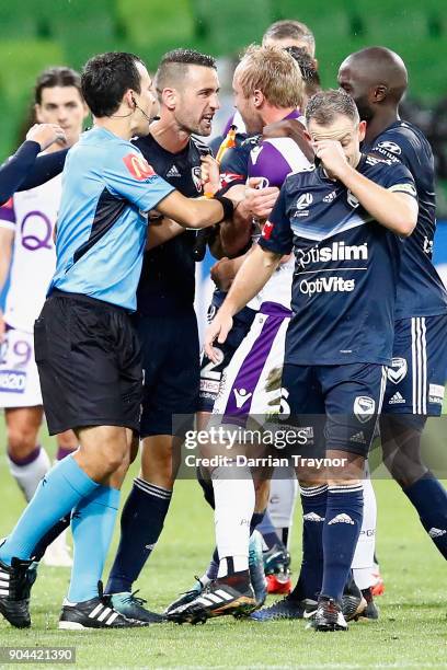 Carl Valeri of Melbourne Victory argues with Mitchell Nichols and Alex Grant of Perth Glory after Grant put a crud tacle on Leroy George of the...