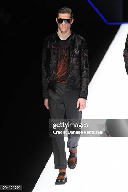 Model walks the runway at the Emporio Armani show during Milan Men's Fashion Week Fall/Winter 2018/19 on January 13, 2018 in Milan, Italy.