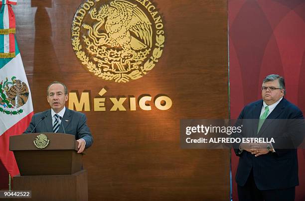 Mexican President Felipe Calderon speaks as Mexican Secretary of Finance and Public Credit Agustin Carstens looks on during a press conference at the...