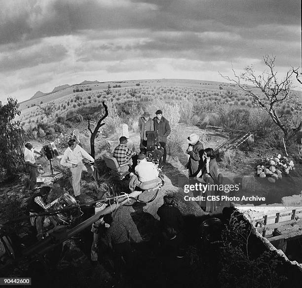 High-angle production still looks down on the cast and crew as they shoot a scene for an episode of the television show 'The Twilight Zone' entitled...