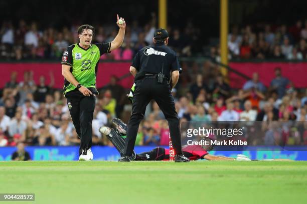 Mitch McClenaghan of the Thunder unsuccessfully appeals for the wicket of Daniel Hughes of the Sixers during the Big Bash League match between the...
