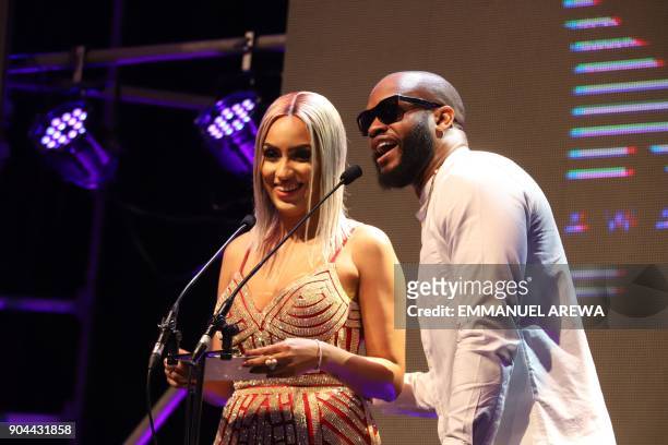 Nigerian hip-hop recording artist Chukie Edozien, aka Lynxxx and Ghanaian actress Juliet Ibrahim steps on stage to present an award at the 2017...